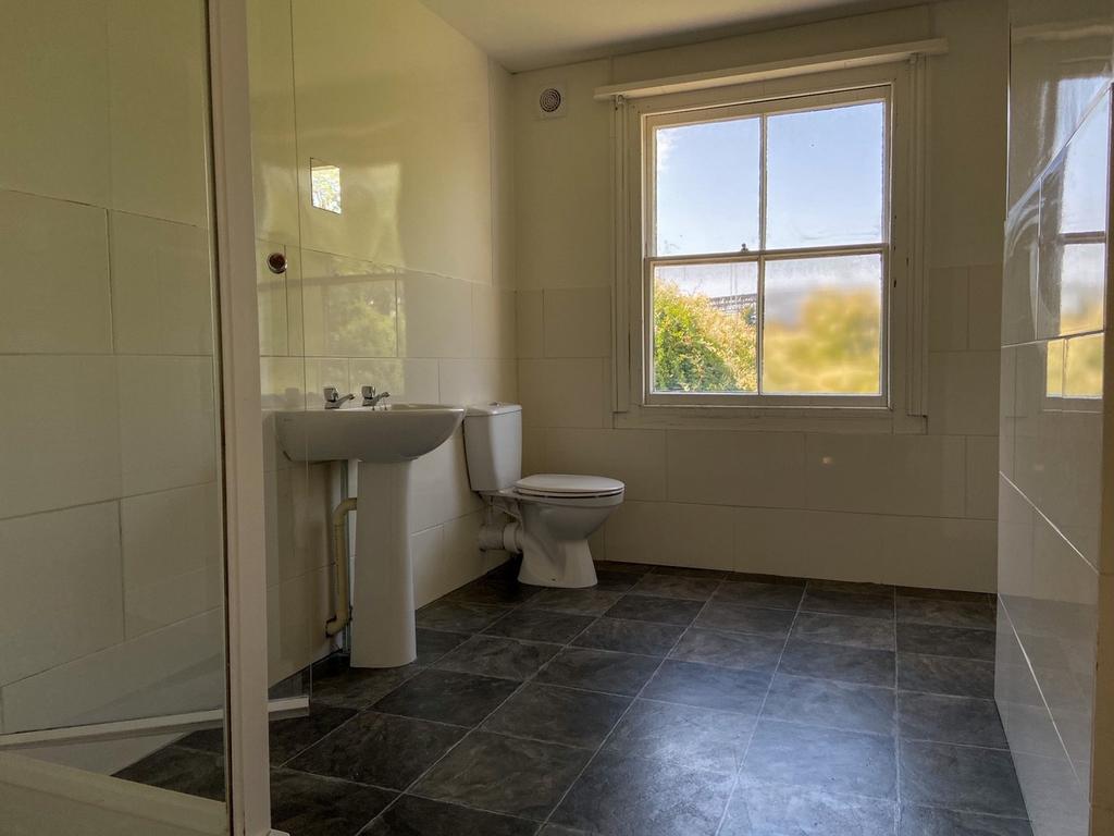 Bright and spacious bathroom with a large windo...