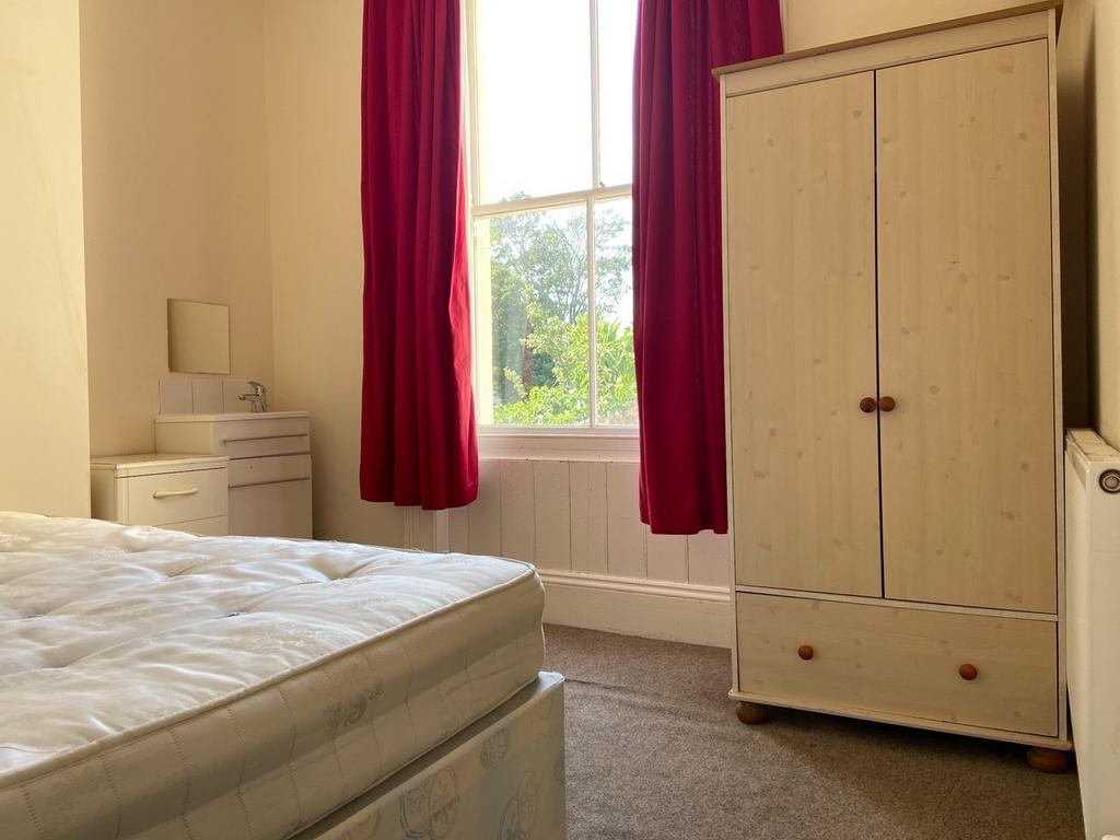 A bright and welcoming double bedroom featuring...
