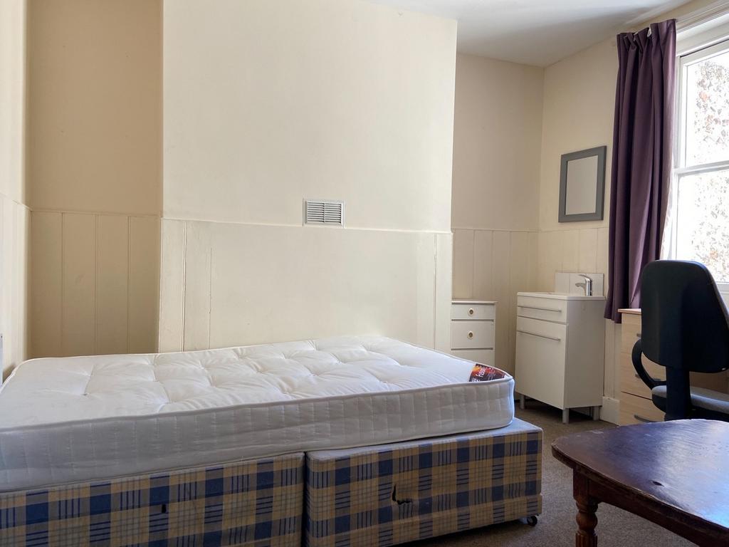 A well-maintained bedroom with a comfortable do...