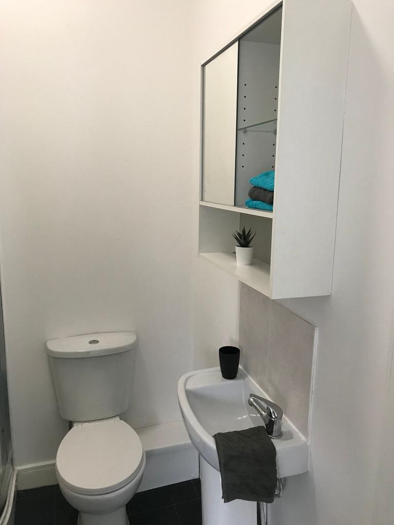 Bright, simply styled bathroom with a modern wh...