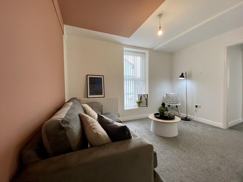 A bright and inviting living room with a cozy s...