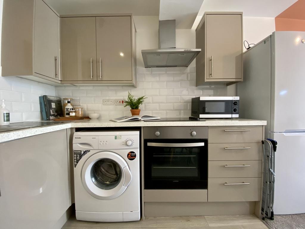 A modern and tidy kitchenette equipped with ess...