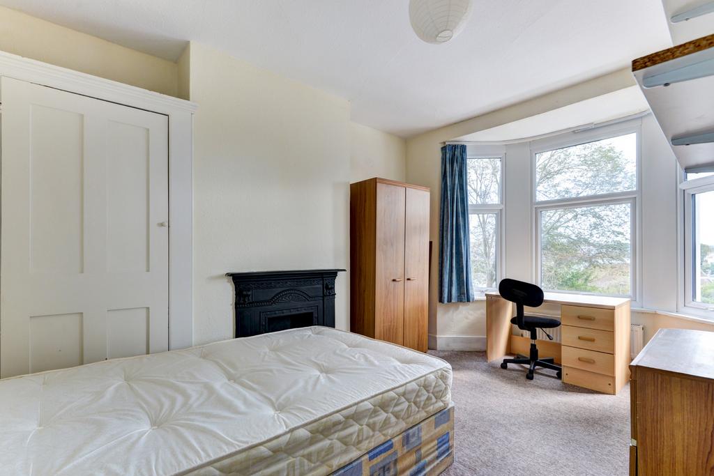 Bright and welcoming bedroom featuring a comfor...