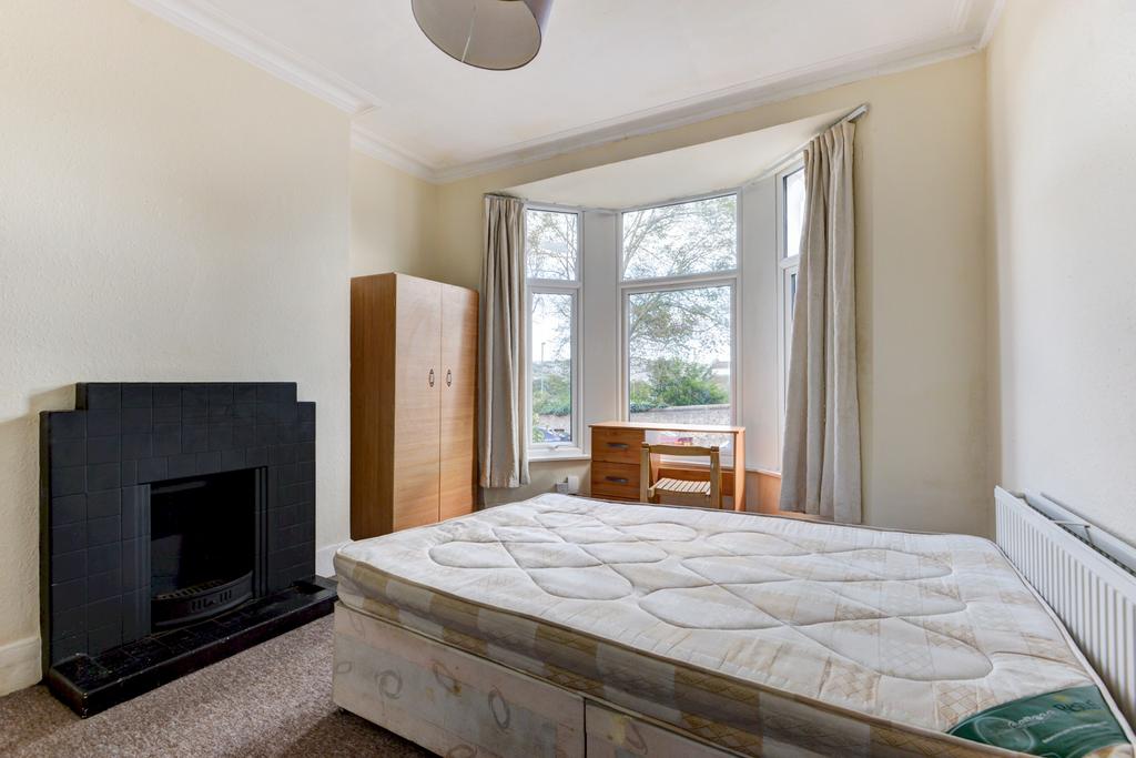 A cozy and well-maintained bedroom featuring a ...