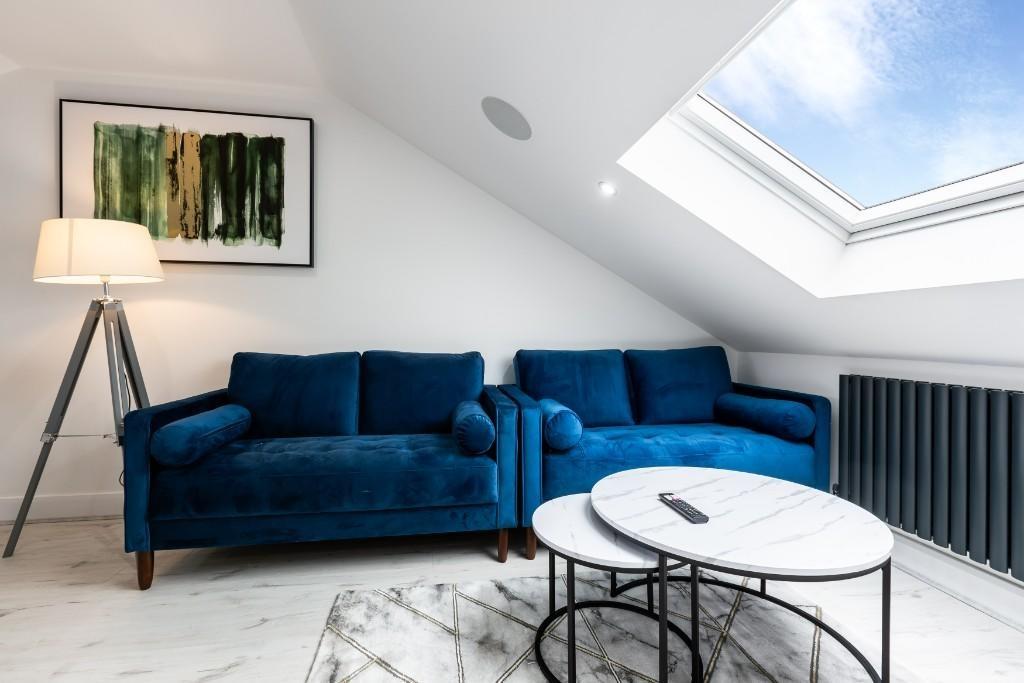 A bright and modern living room featuring a com...