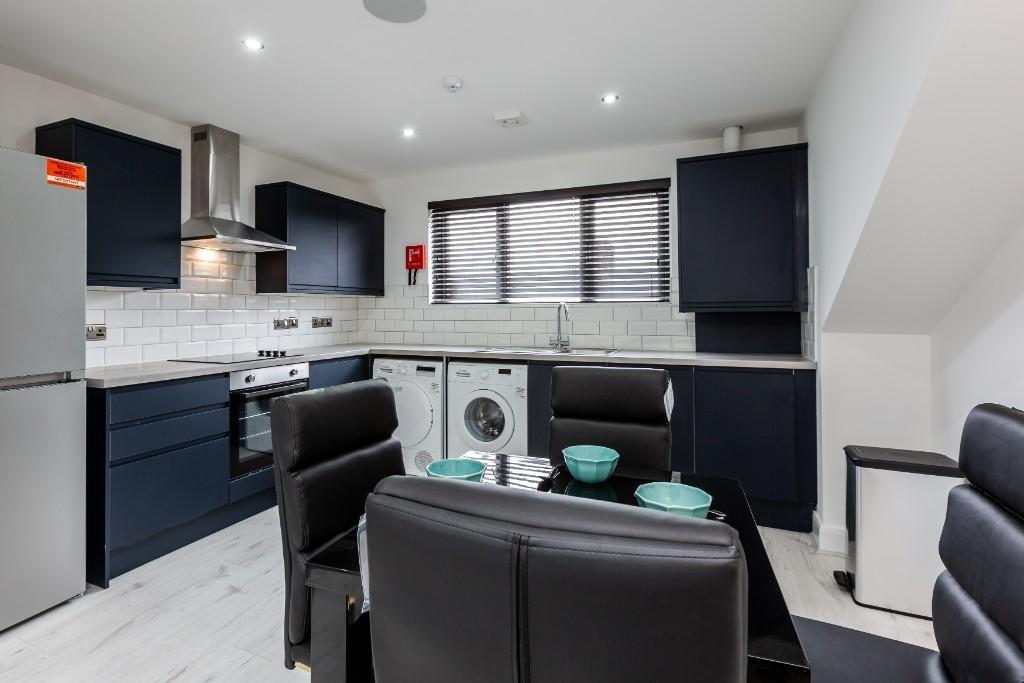 Modern, clean kitchen with ample cabinetry in d...