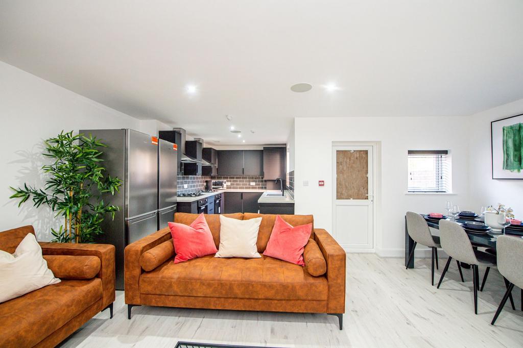 Bright and modern living room featuring stylish...