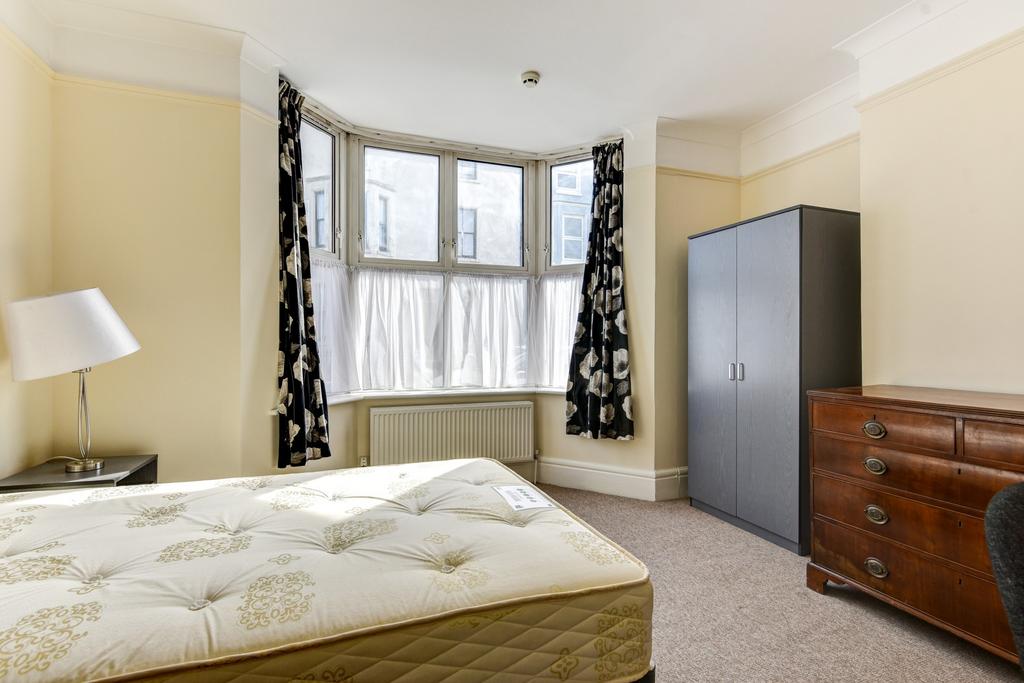 A bright and well-maintained master bedroom fea...