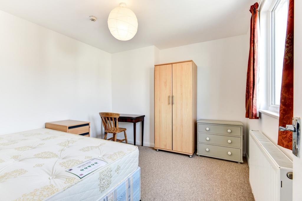 A well-maintained bedroom with natural light st...