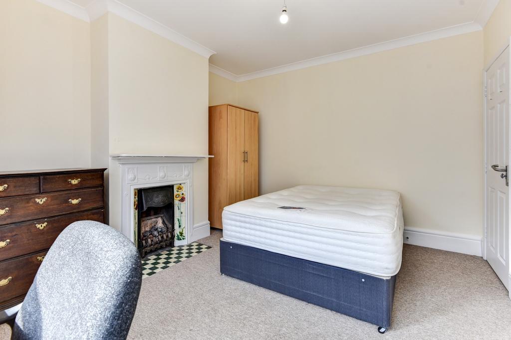 A clean and inviting bedroom featuring a comfor...