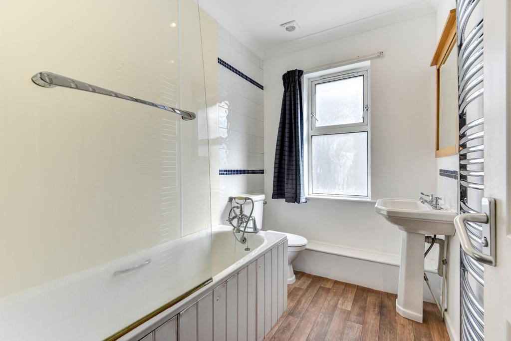 A spacious and well-maintained bathroom featuri...