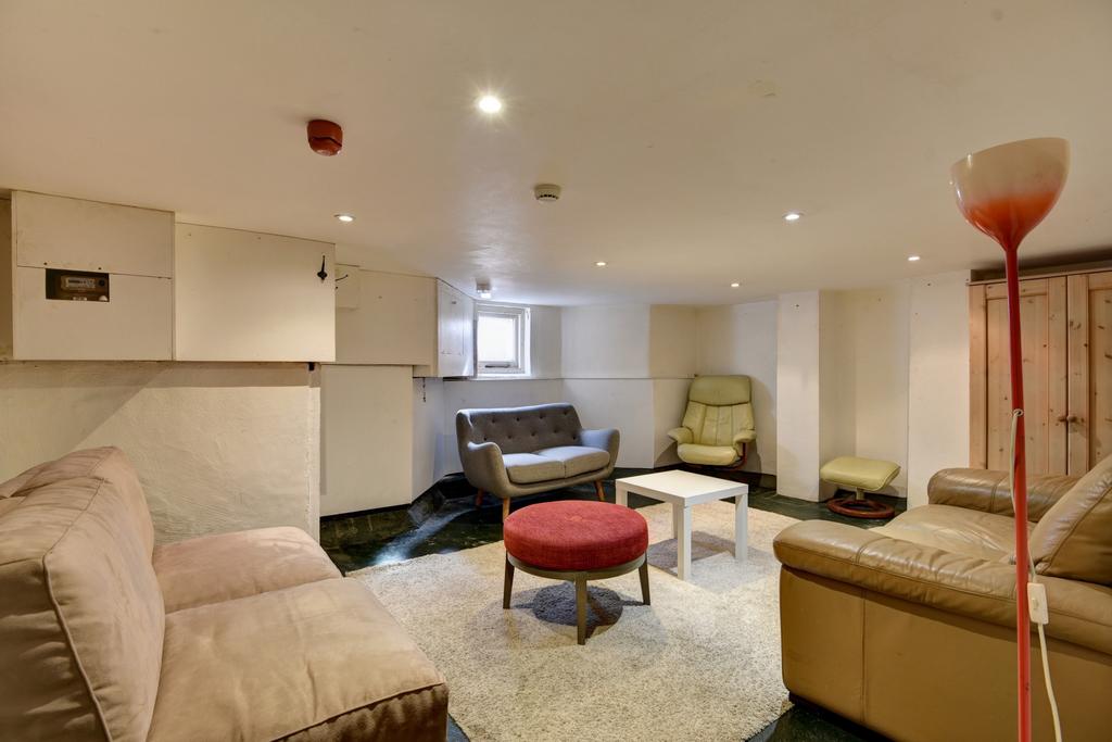 A spacious, well-lit living room featuring a co...