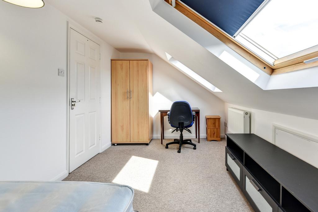 A bright and tidy study area with a desk and ch...