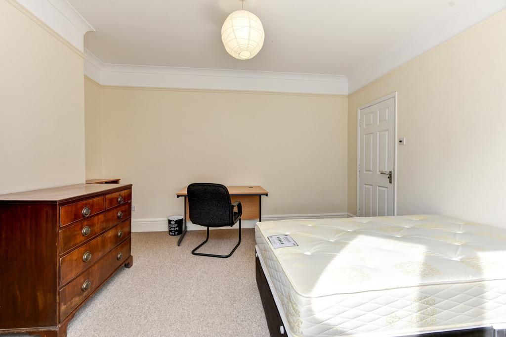 A bright and spacious master bedroom featuring ...