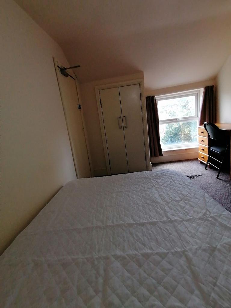 Bright room with a large bed, built-in wardrobe...