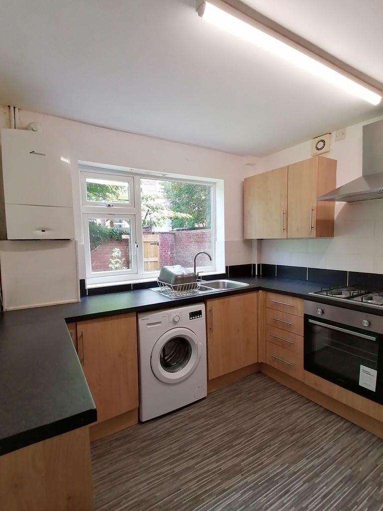 Well-presented fitted kitchen with light wood c...