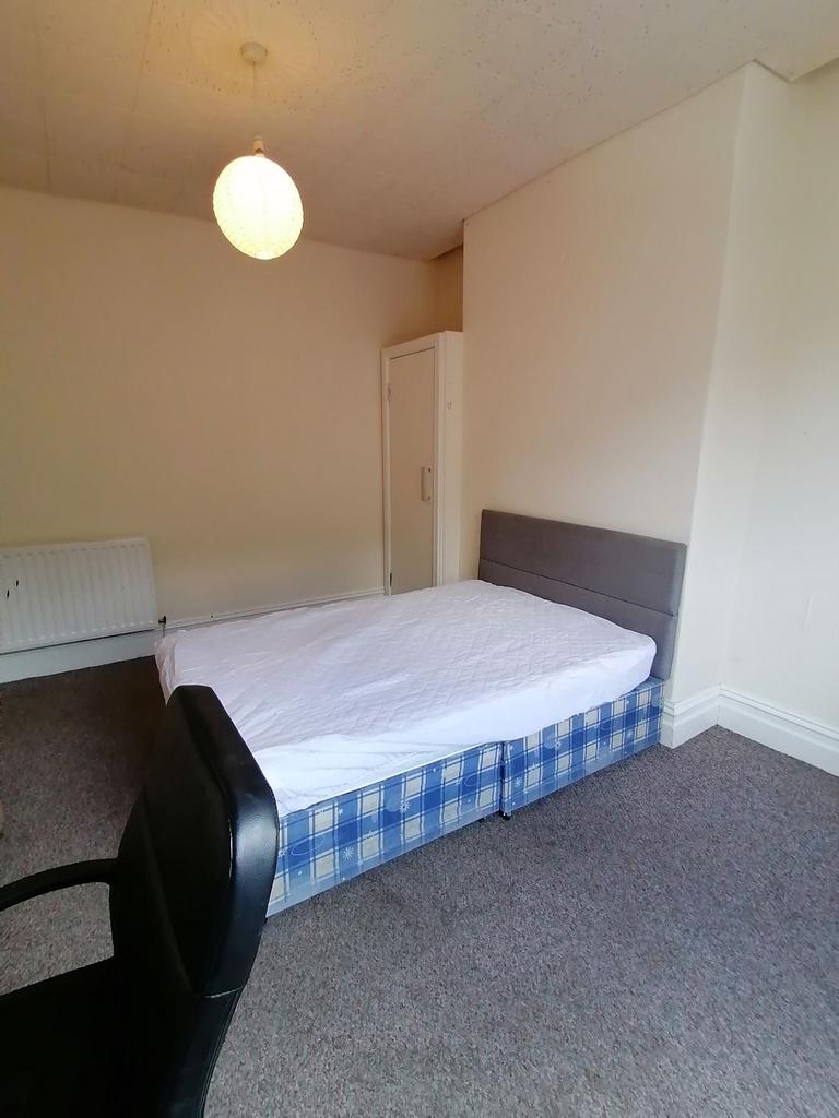 Simple furnished bedroom with a double bed on a...