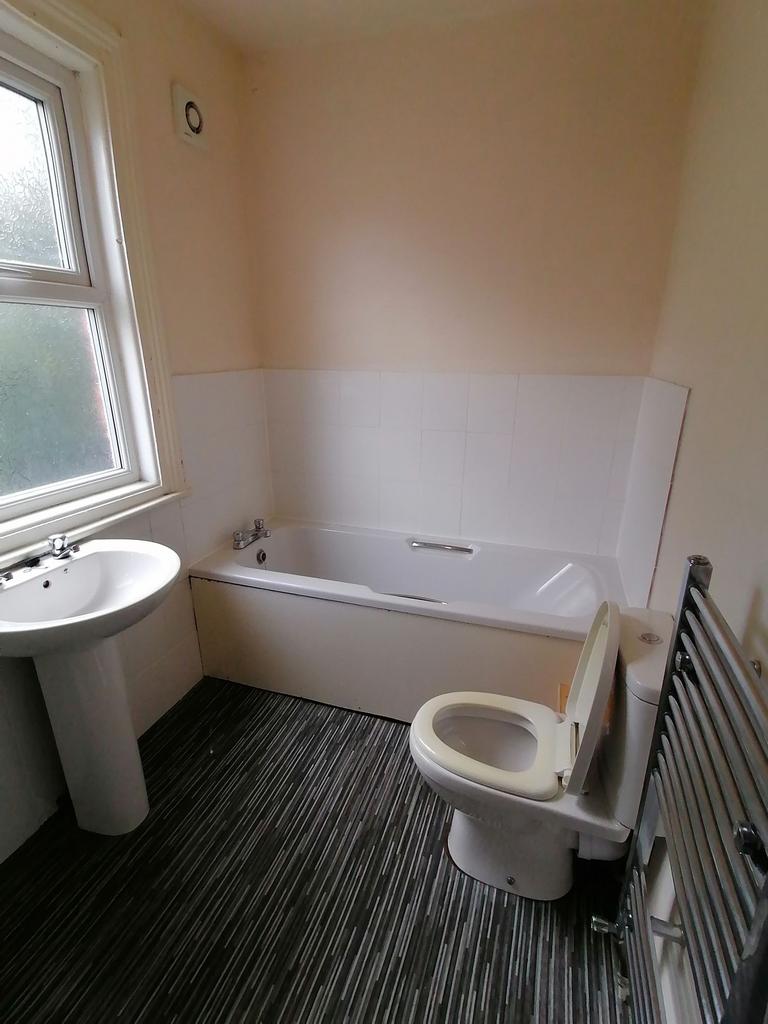 Bright, tidy bathroom with a full-size bathtub,...