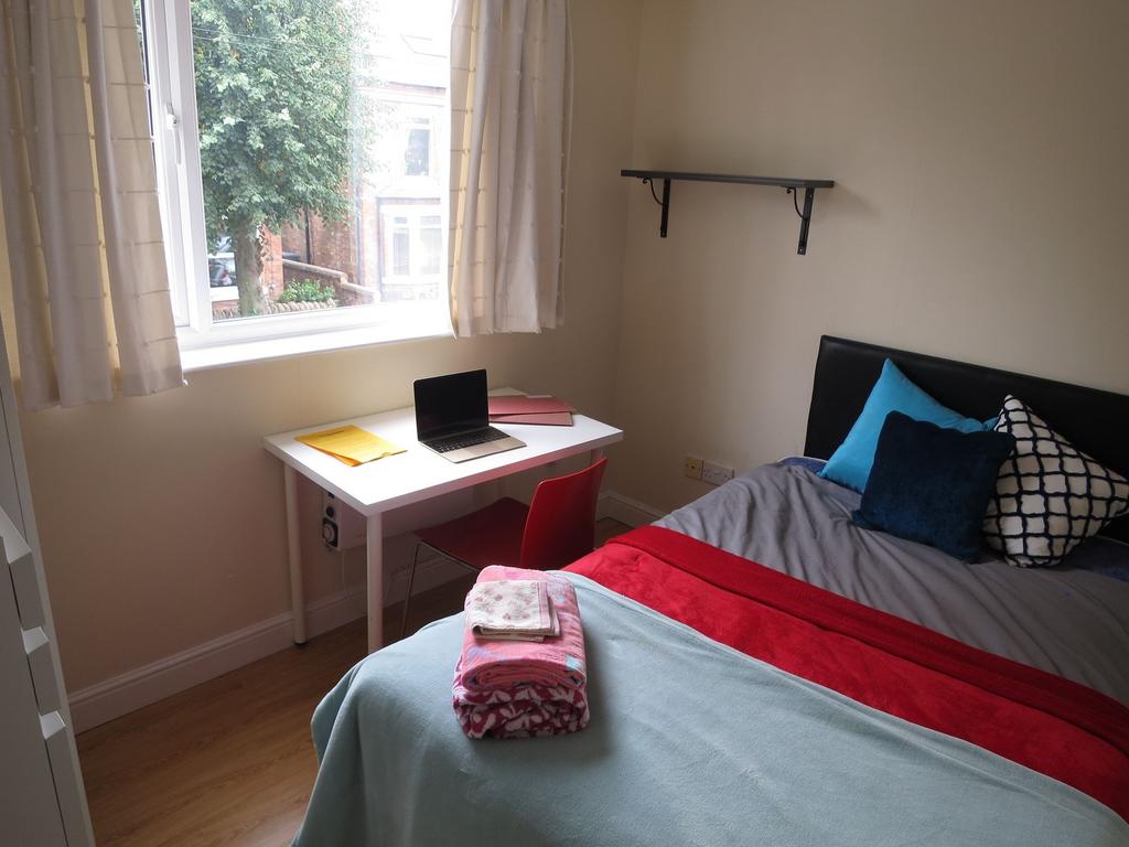 Bright, neatly presented bedroom with a comfort...