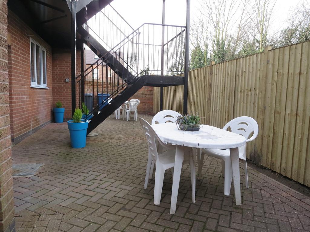 Private paved courtyard with outdoor dining set...
