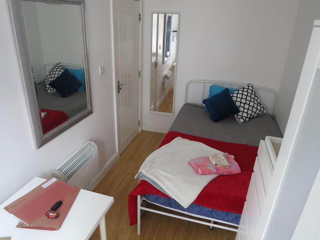 Bright, tidy single bedroom with a neat bed dre...