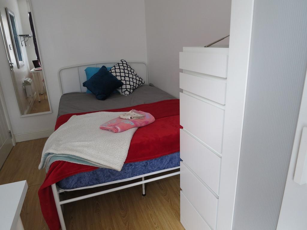 Bright, tidy bedroom with a neatly made double ...