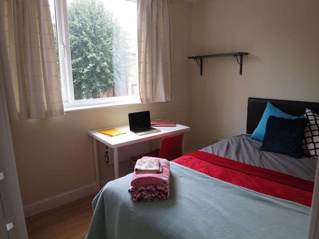 Bright, neatly presented bedroom with a comfort...