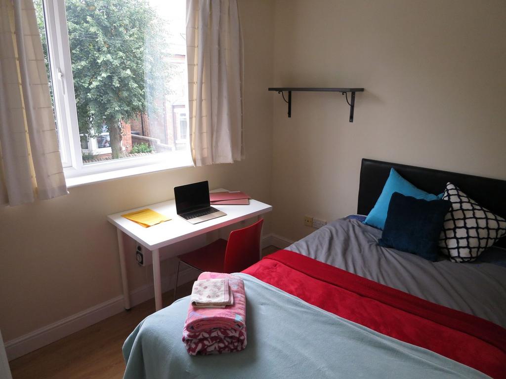 Bright, neatly presented bedroom with a large w...