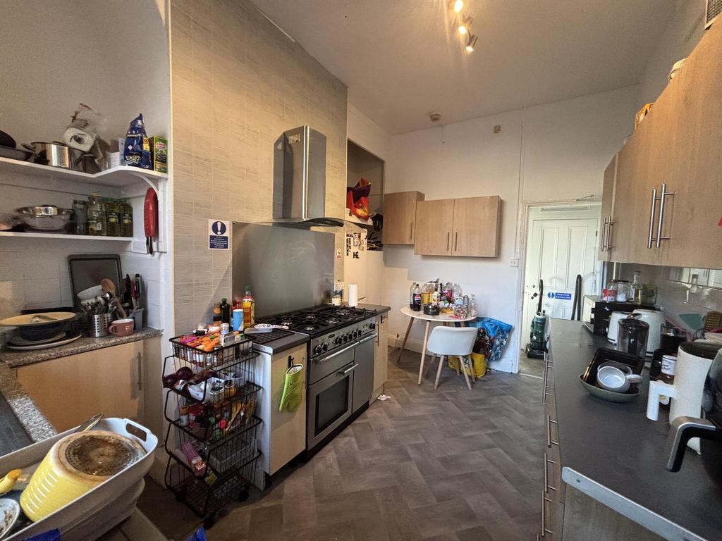Bright, well-equipped galley kitchen with full-...