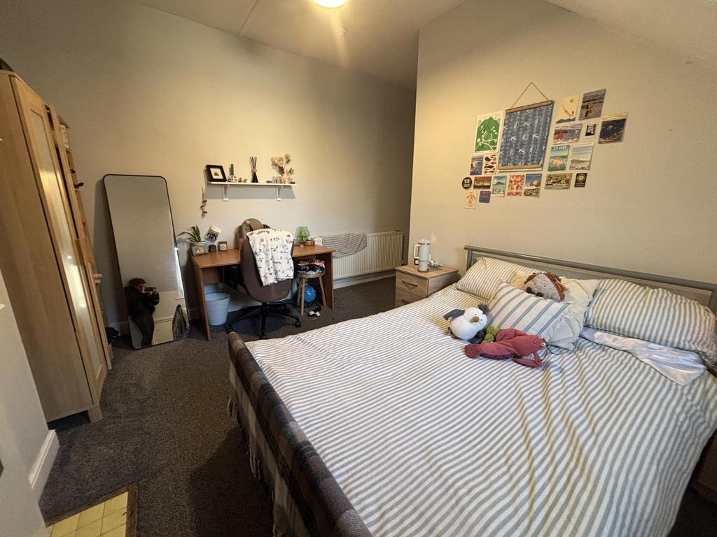 Bright, neatly kept double bedroom featuring a ...