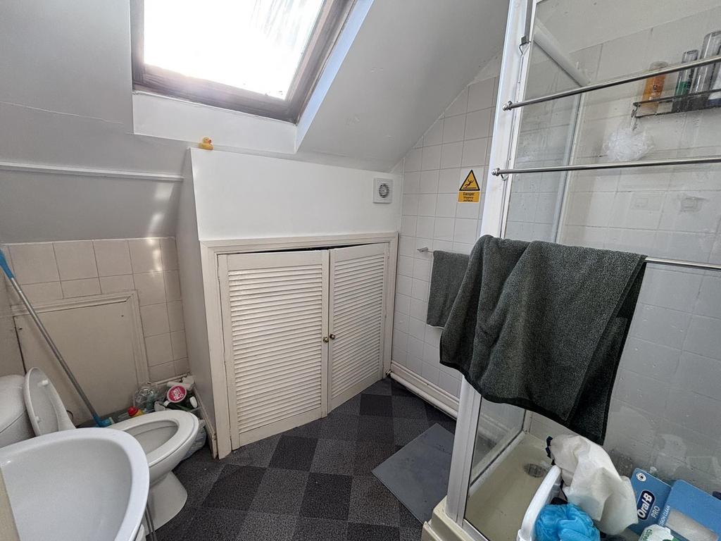 Compact bathroom with a shower cubicle, skyligh...