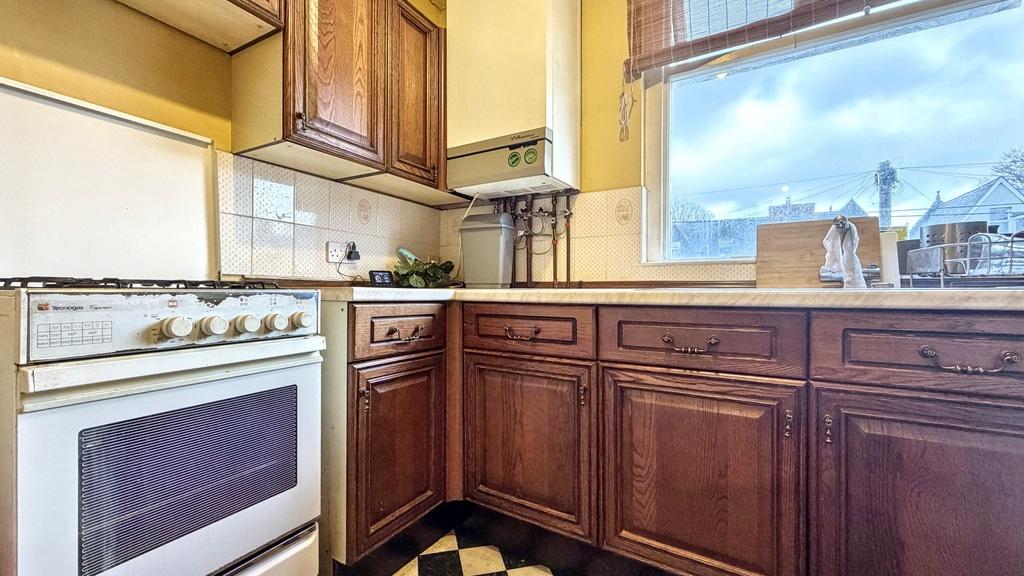 Bright kitchen with classic wooden cabinetry, g...