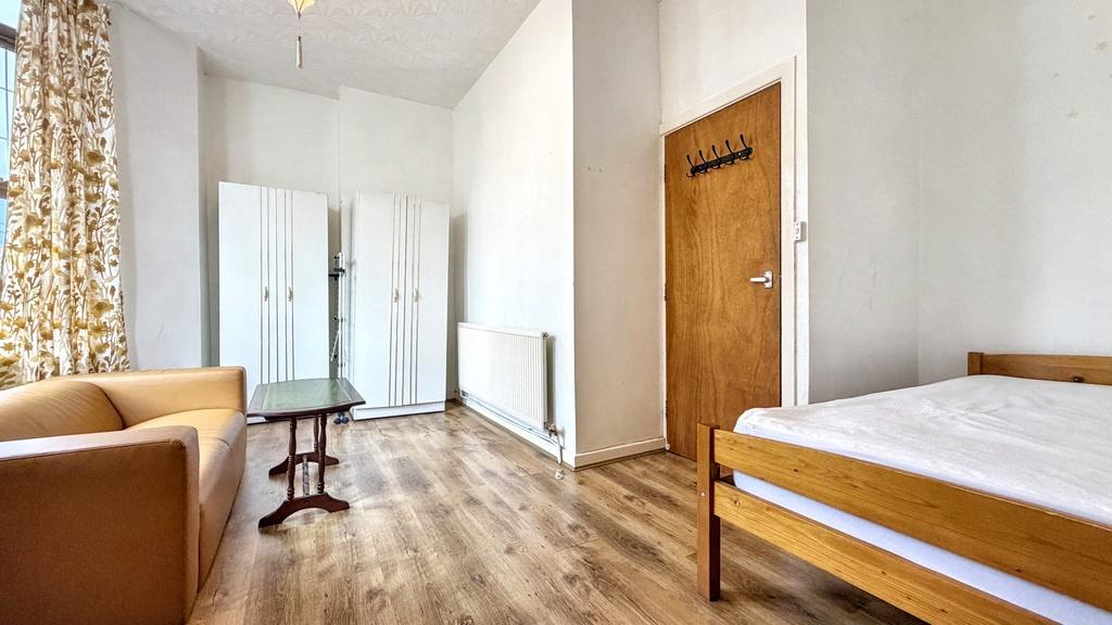 Bright, simply furnished bedroom with a comfort...