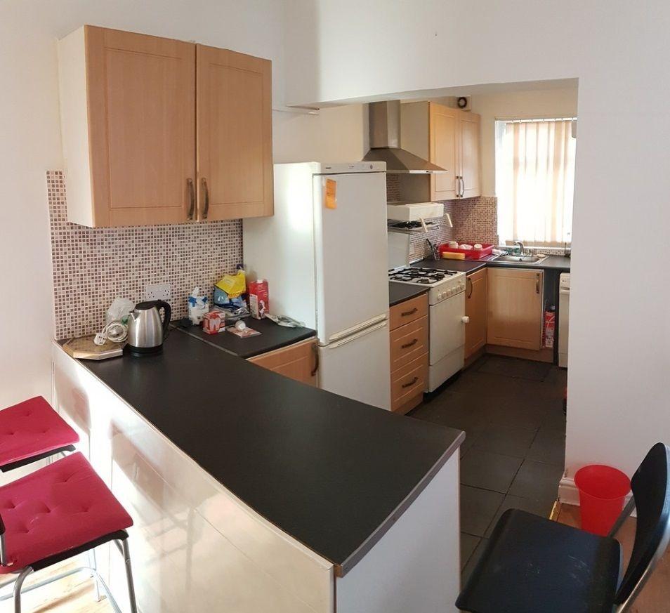 Bright galley-style kitchen with a breakfast ba...