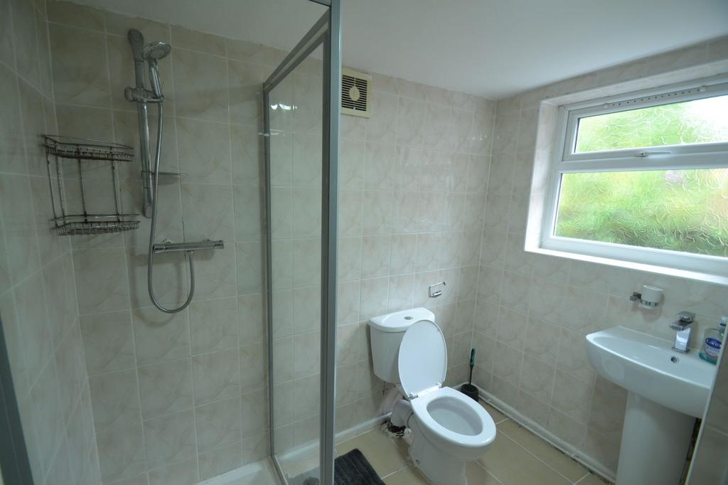 A clean and functional bathroom featuring a sho...