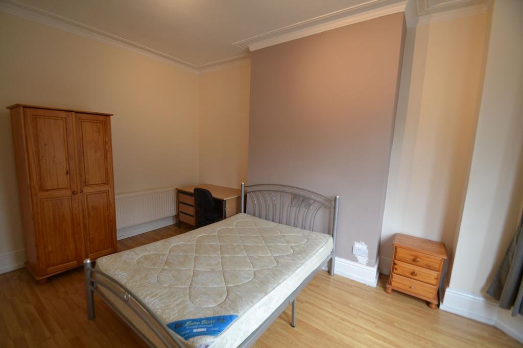 A neatly maintained single bedroom featuring a ...