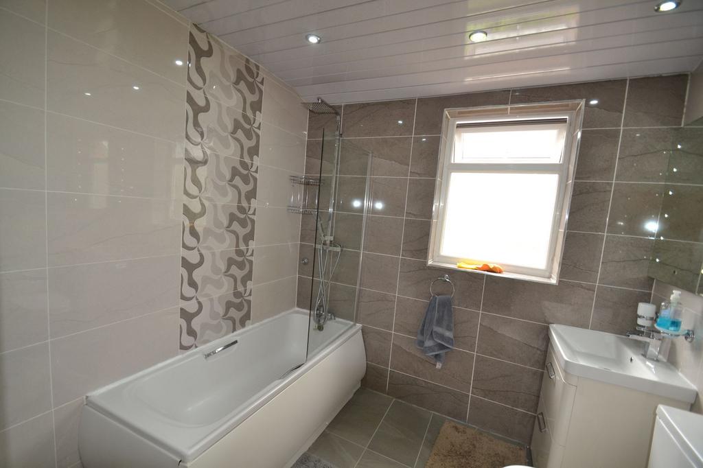 Modern bathroom featuring a spacious bathtub wi...