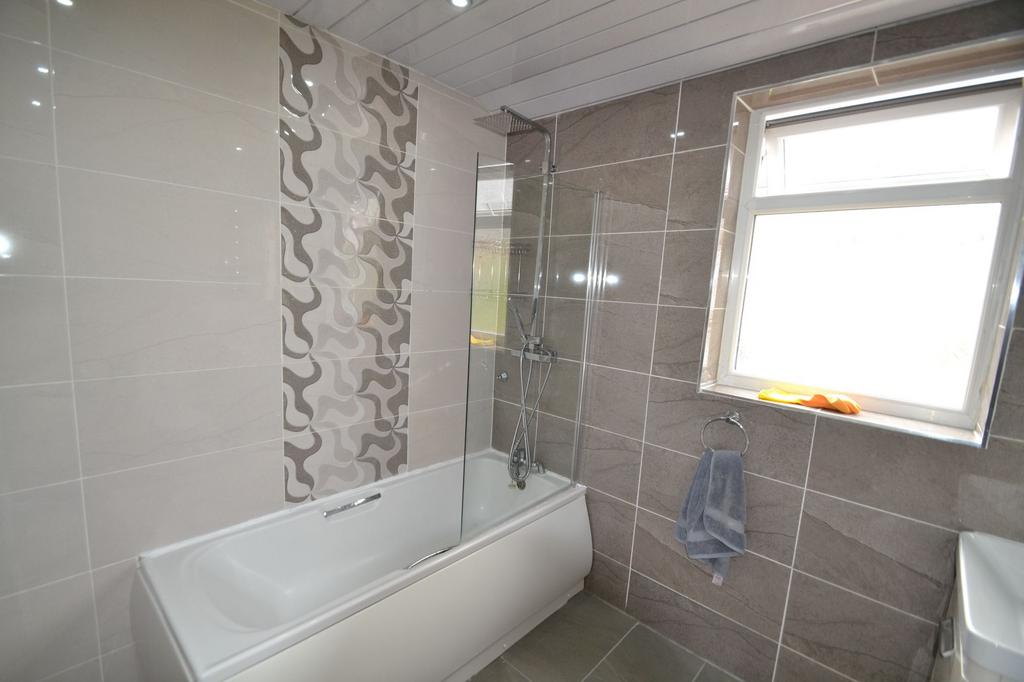 Bright and modern bathroom featuring a large ba...