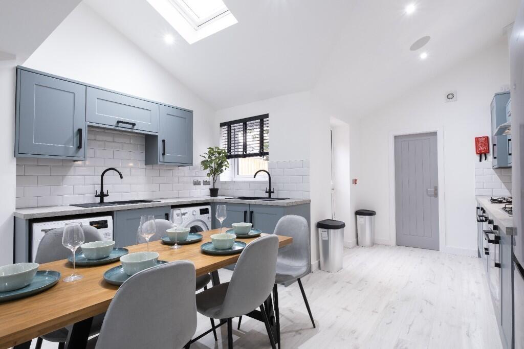 Bright and modern kitchen with ample counter sp...