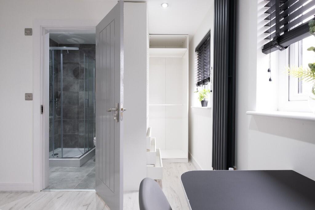 A spacious, modern bathroom featuring a large s...