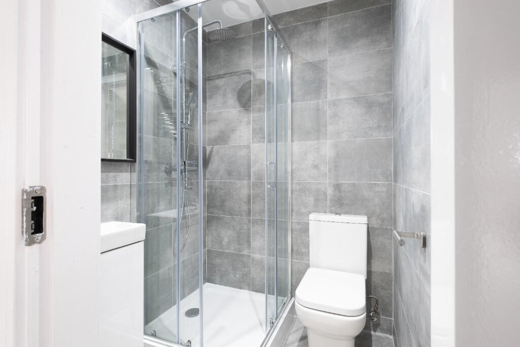 A modern, clean bathroom featuring a spacious s...