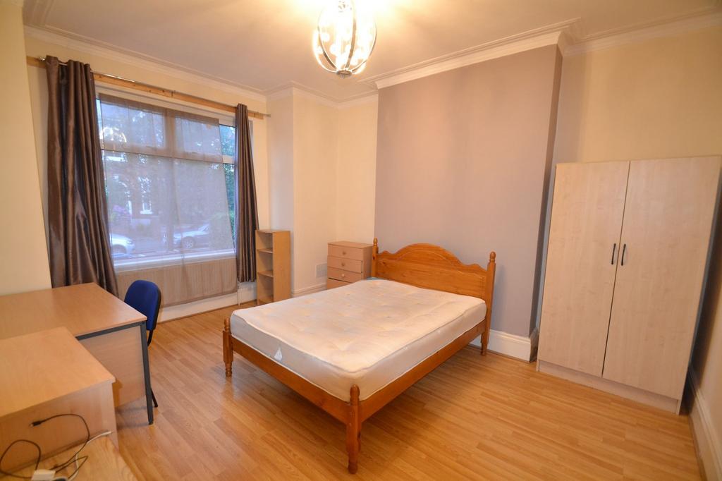 A cozy, well-maintained bedroom featuring a woo...