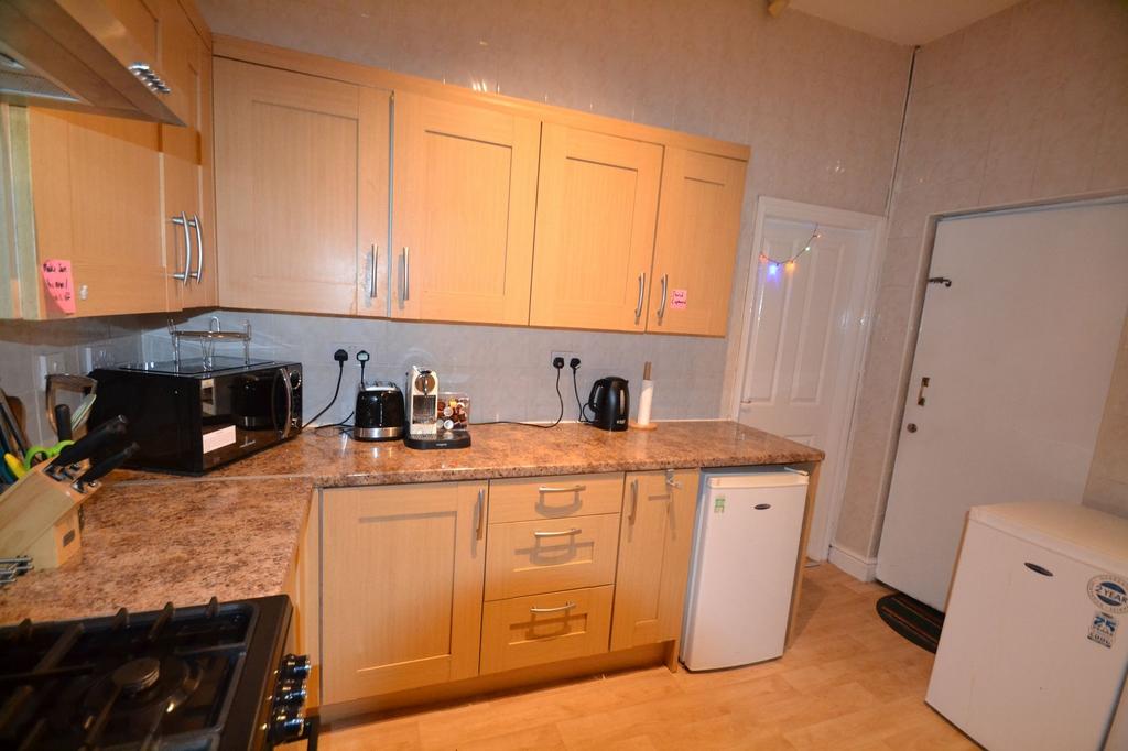 Modern kitchen featuring wooden cabinetry, a Gr...