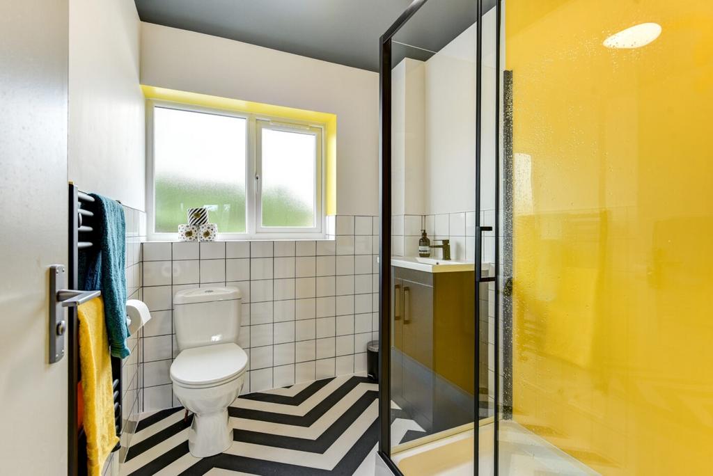 Bright, modern bathroom with bold design accent...
