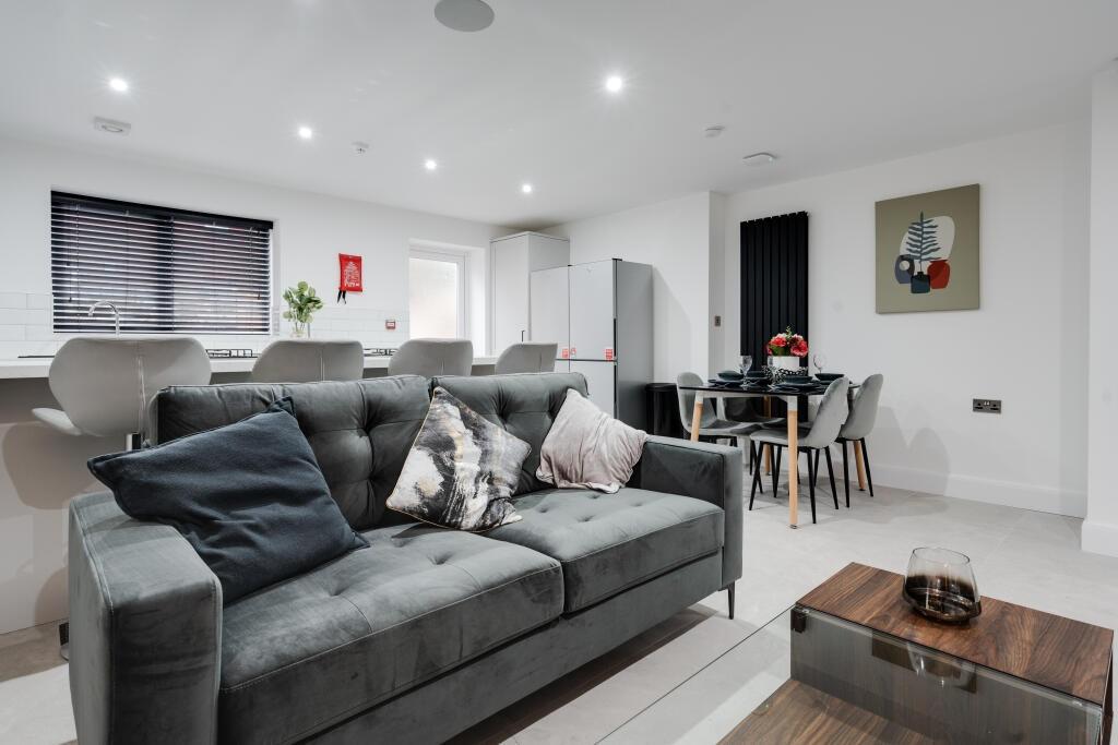 A spacious and well-lit contemporary living roo...