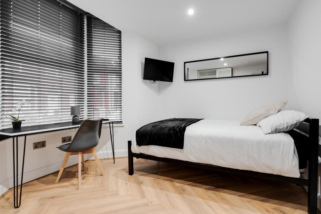 A bright and well-maintained master bedroom fea...