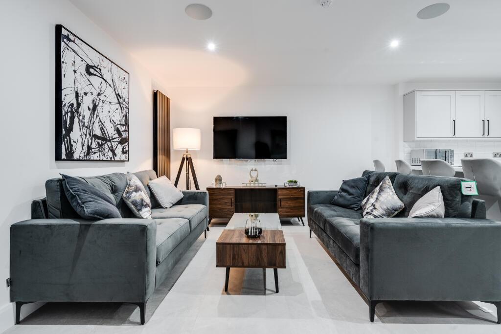 A contemporary and spacious living room featuri...