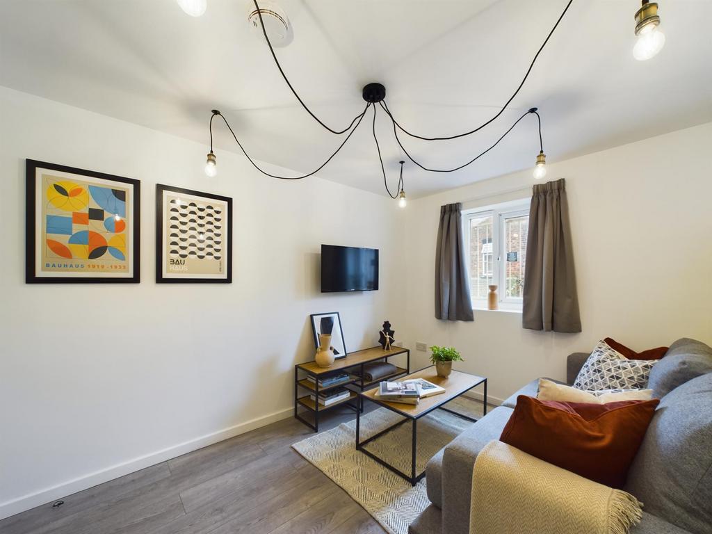 A bright and inviting living room featuring con...
