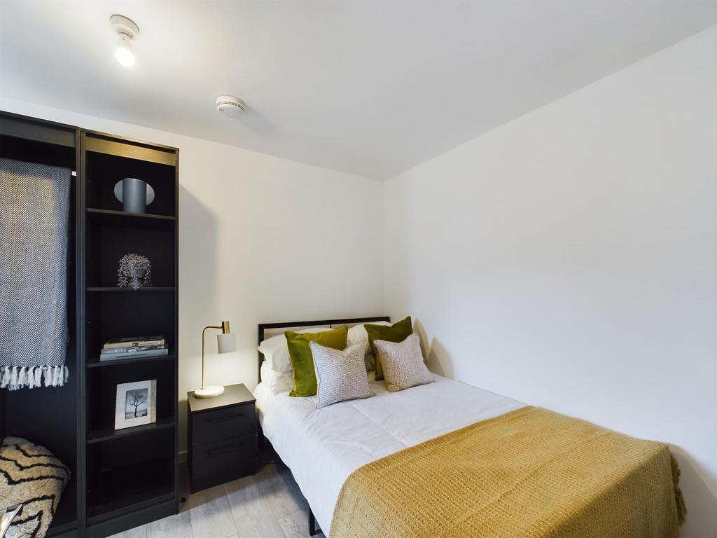 A spacious and well-lit master bedroom featurin...