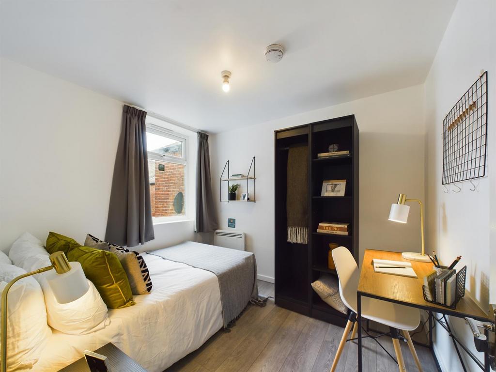 Bright, neatly presented bedroom with a comfort...